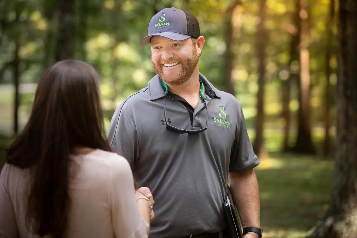 A Sylvan Scapes arborist meeting a homeowner on their property at the start of an estimate